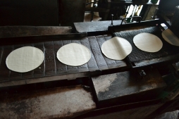 Production belt after pressing and cutting the dough in shape